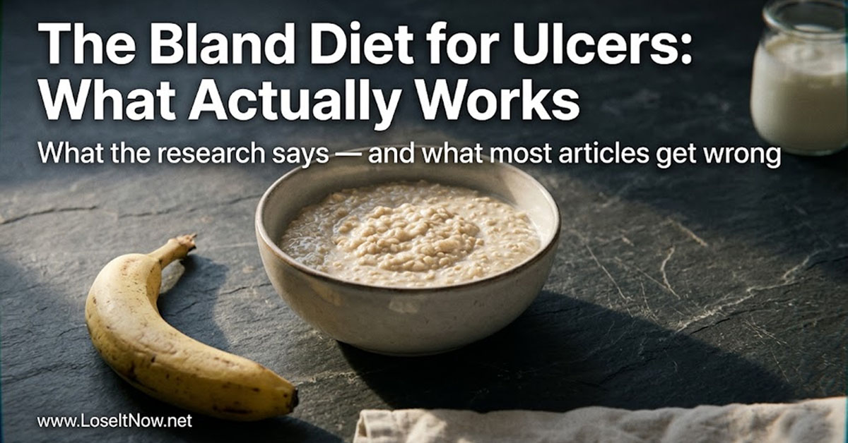 A ceramic bowl of oat porridge and banana on slate — foods commonly recommended in a bland food diet for ulcers, photographed in natural morning light.