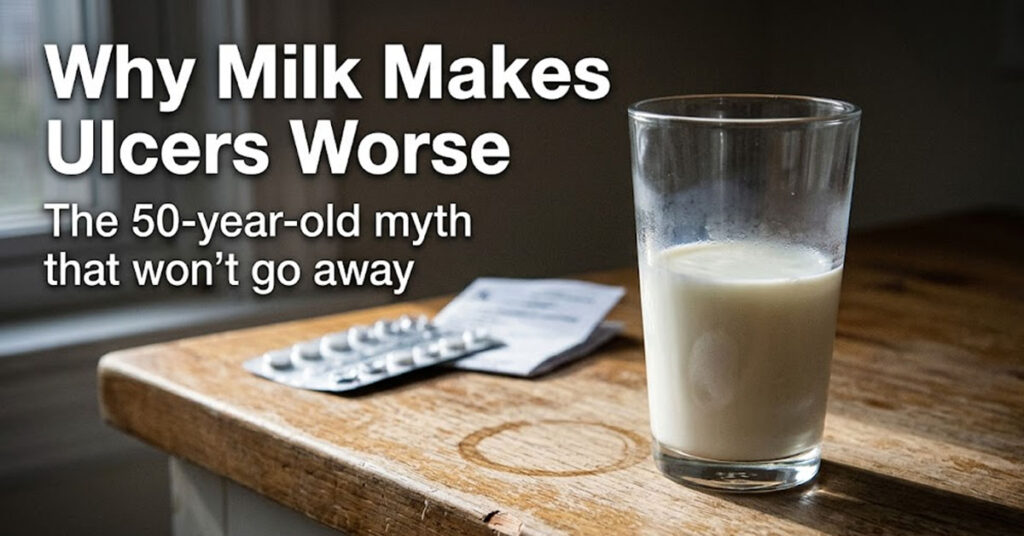 A half-empty glass of milk on a worn wooden counter - the milk myth debunked in research on bland food diets for ulcers.