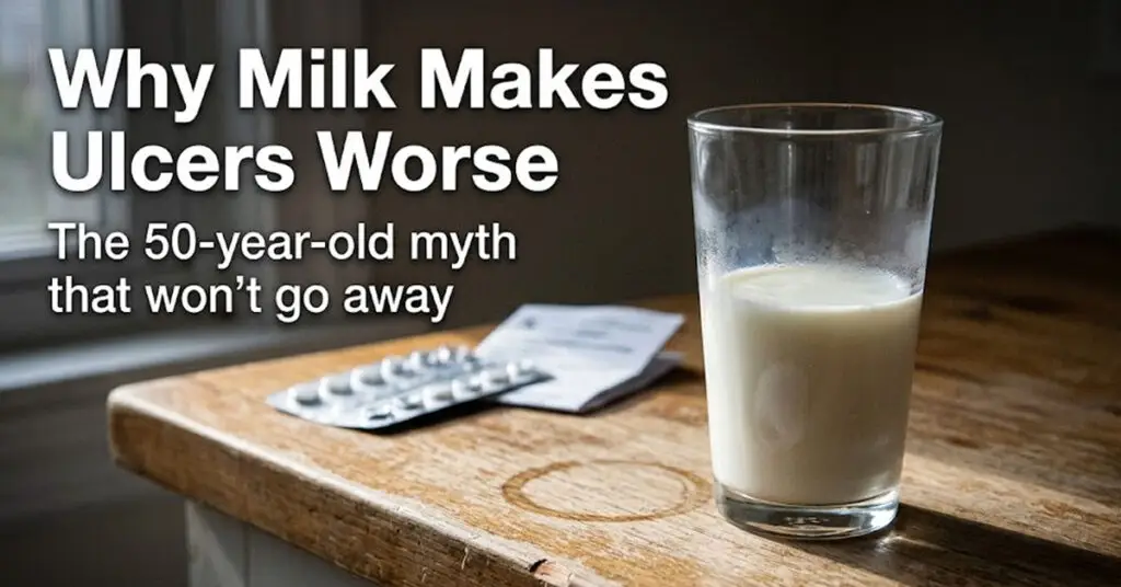 A half-empty glass of milk on a worn wooden counter - the milk myth debunked in research on bland food diets for ulcers.